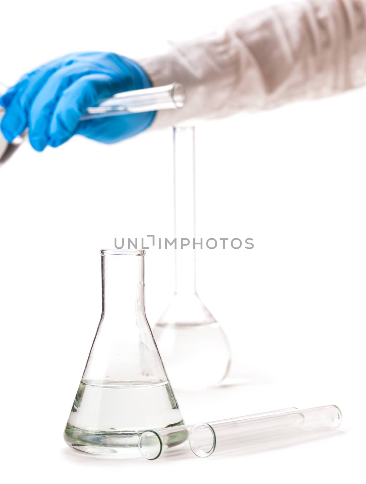 assistant pours reagent in the flask on a white background