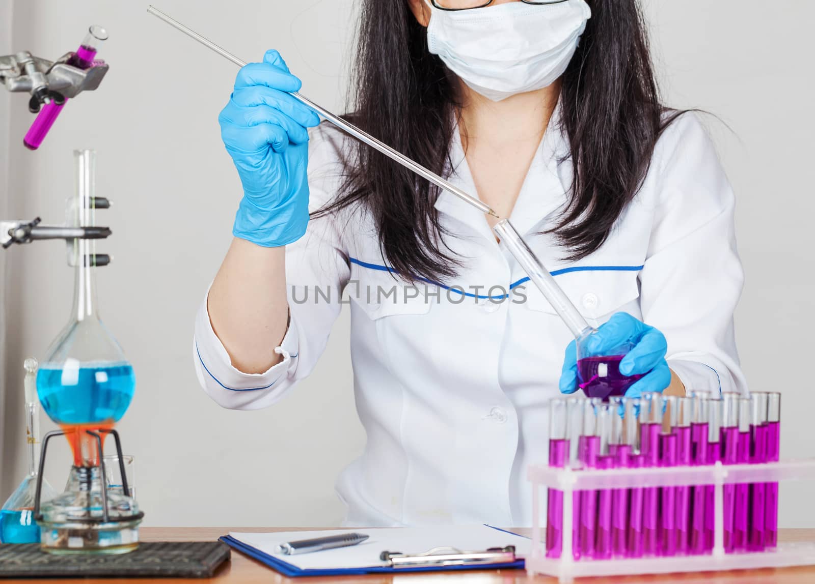 laboratorian works with reagents closeup on a light background