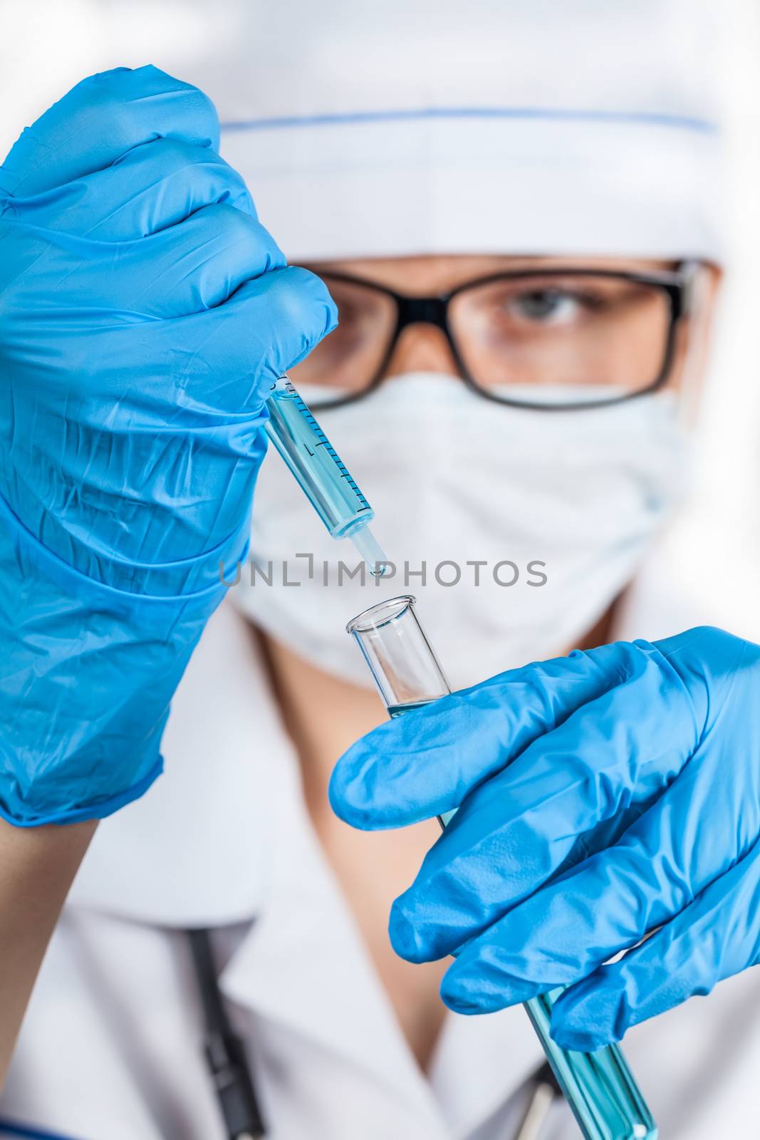 assistant of dripping reagent in a test tube closeup