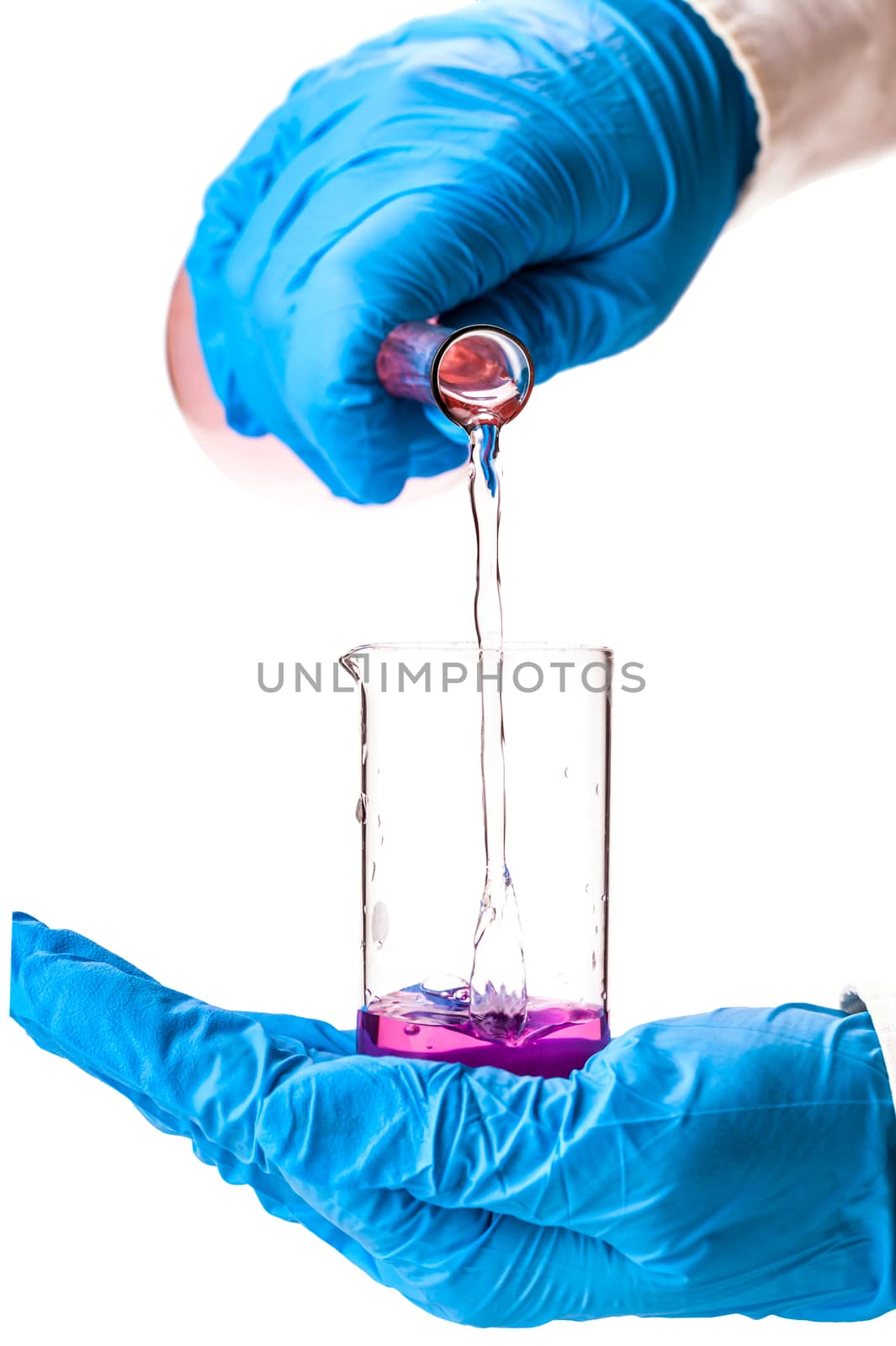 assistant reagent pouring into the flask on a white background