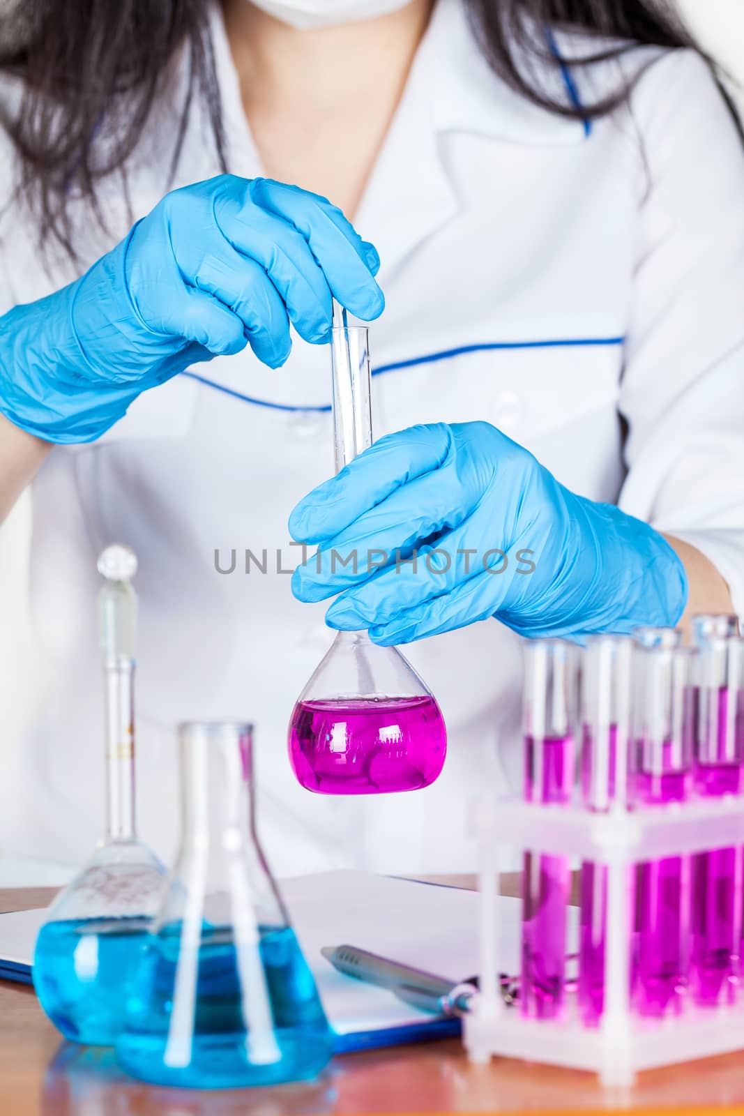 assistant works with reagents on a light background