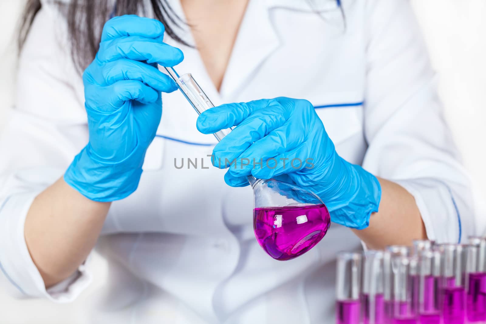 assistant works with reagents closeup on a light background