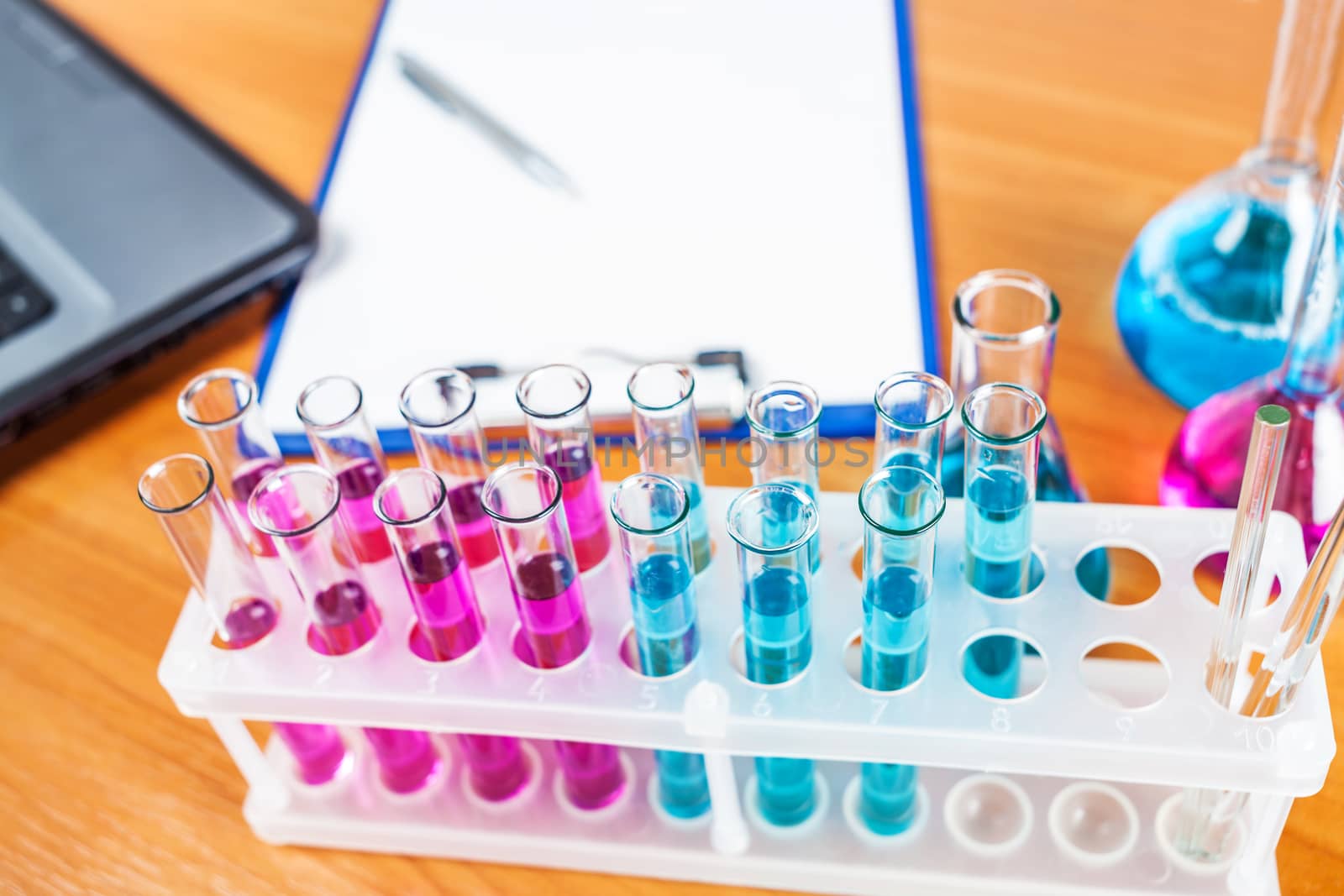 test tubes and flasks with reagents closeup on wooden background
