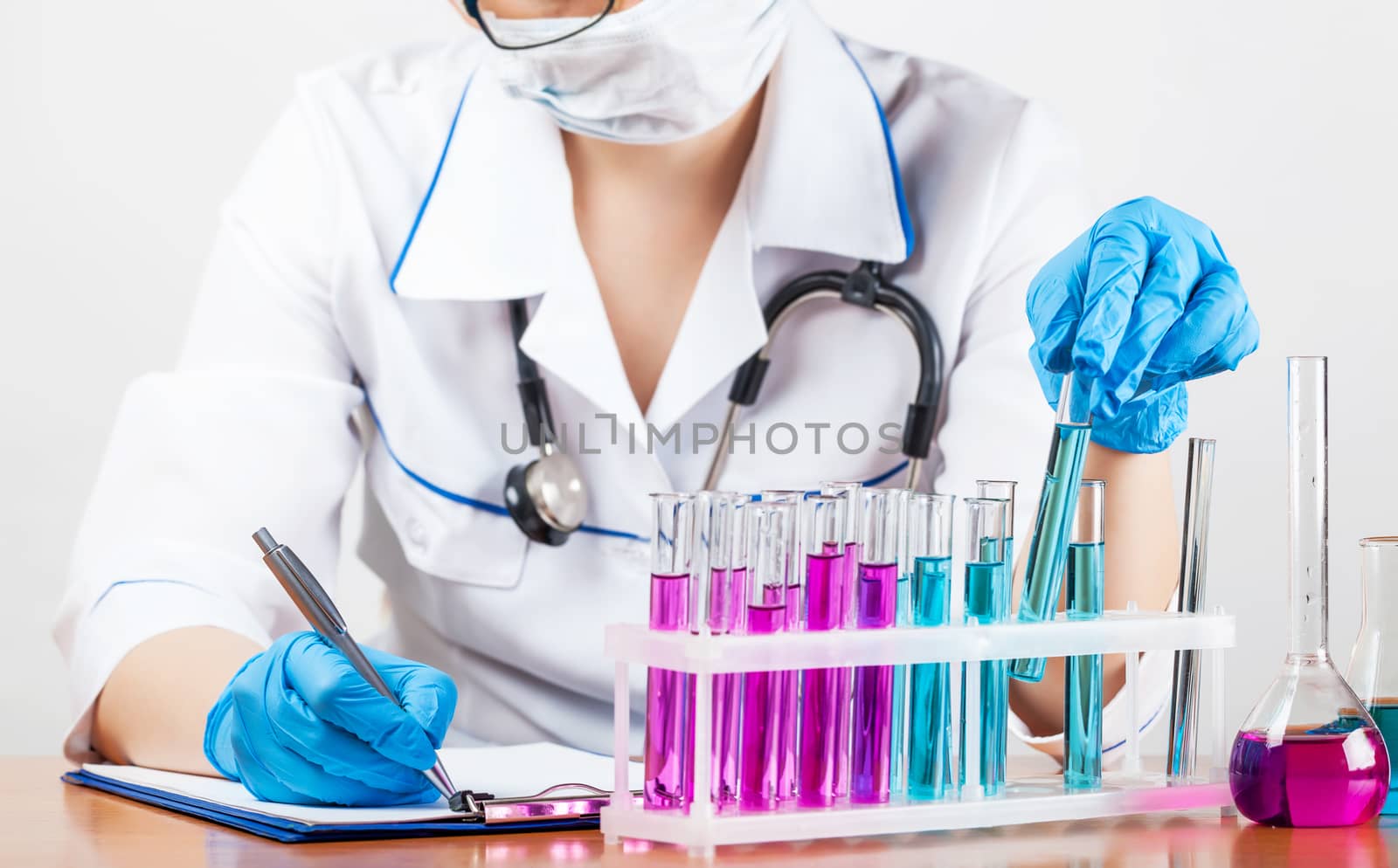 laboratorian examines the contents of the test tubes closeup 