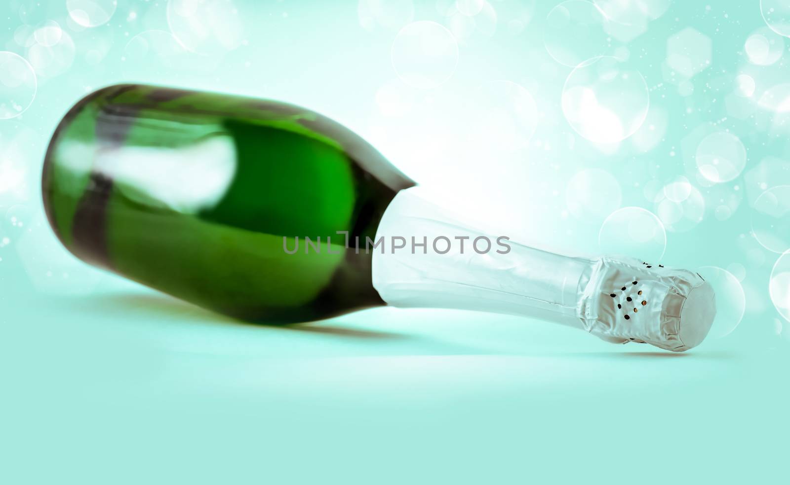 a bottle of sparkling champagne on a blue background