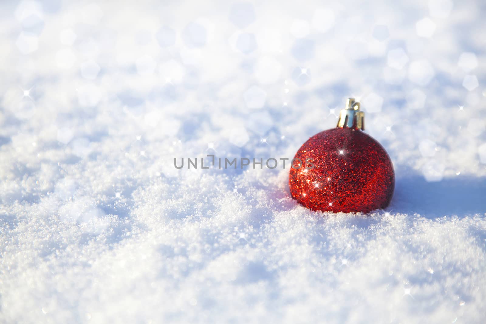 shiny christmas decoration lying on snow background