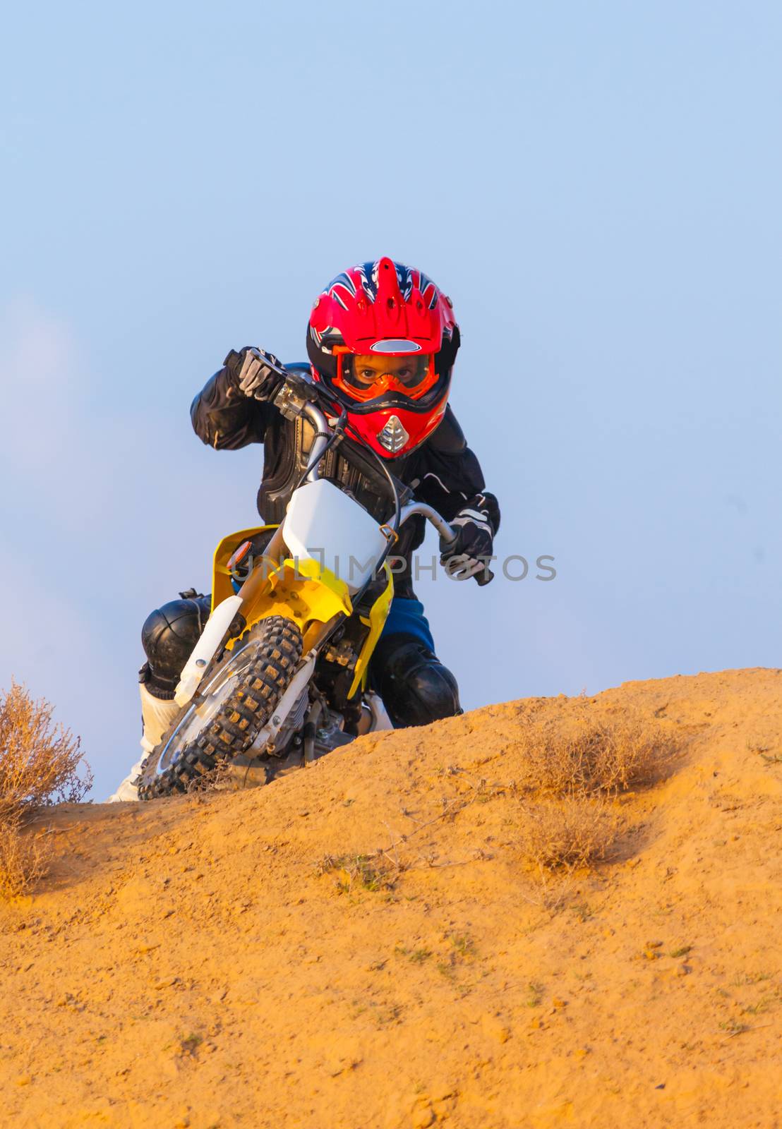 boy racer on a motorcycle in the desert, summer day