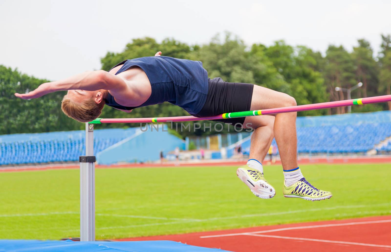 athlete jumps in height, sports background