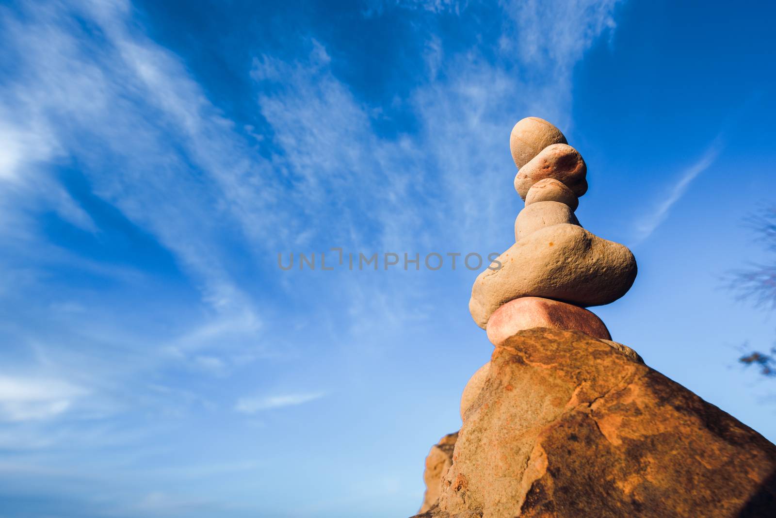 Balancing of stones each other on sky background