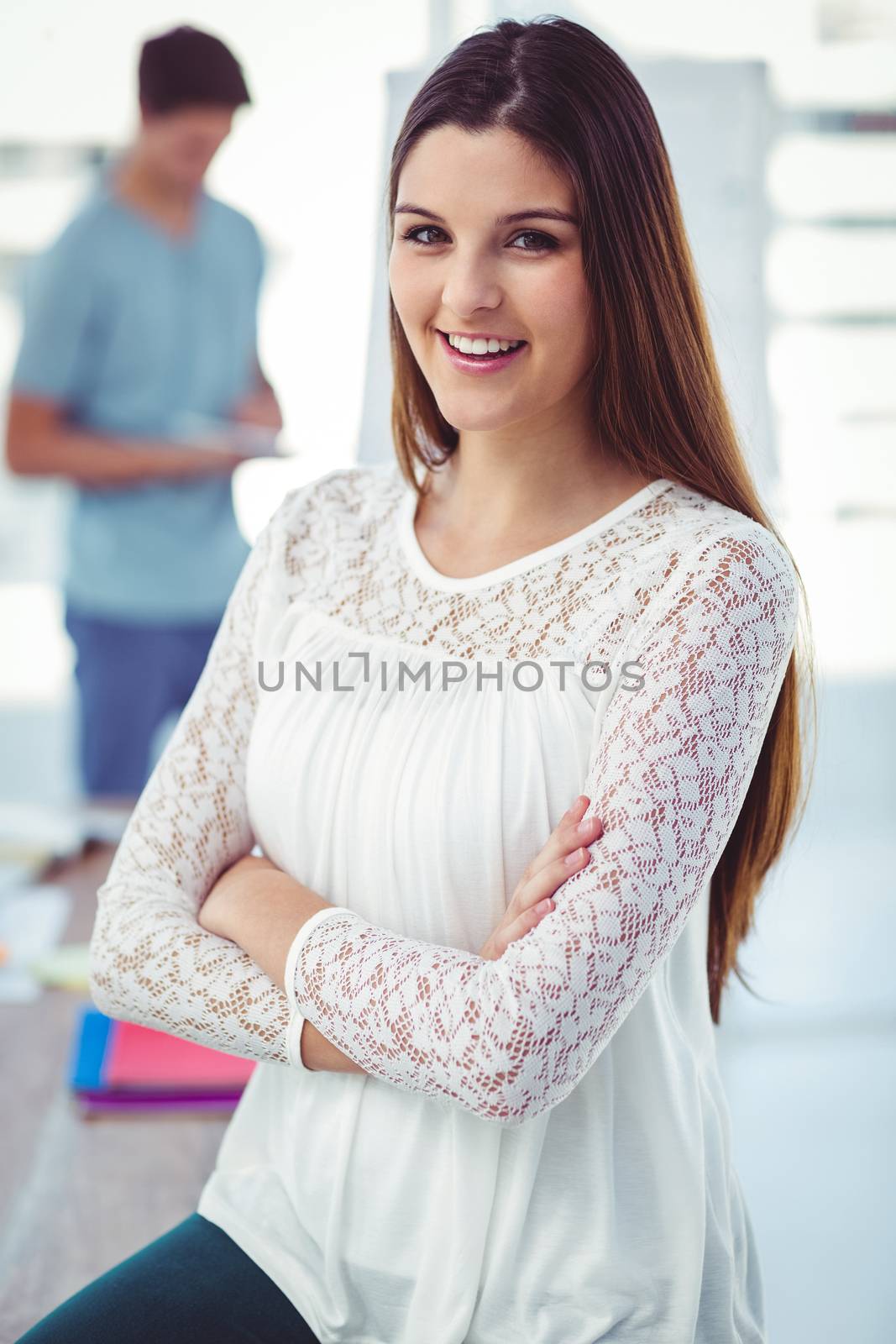 Young creative worker smiling at camera in casual office