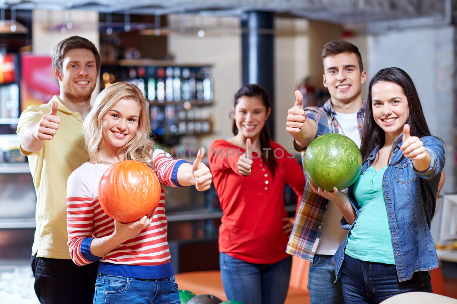 happy friends in bowling club by dolgachov