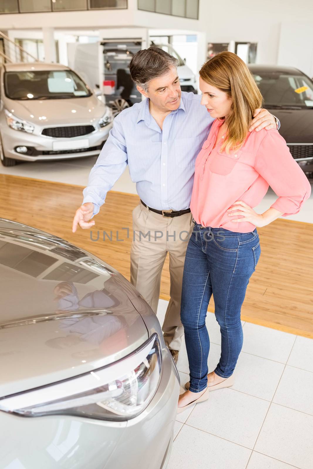 Couple talking together while looking at car by Wavebreakmedia