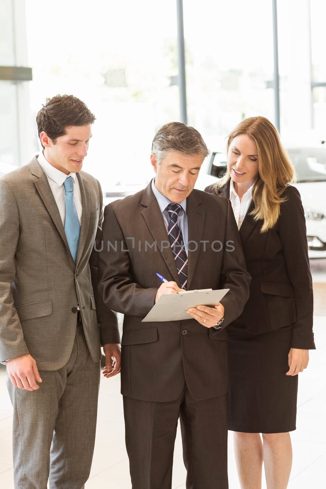 Group of smiling business team standing together by Wavebreakmedia