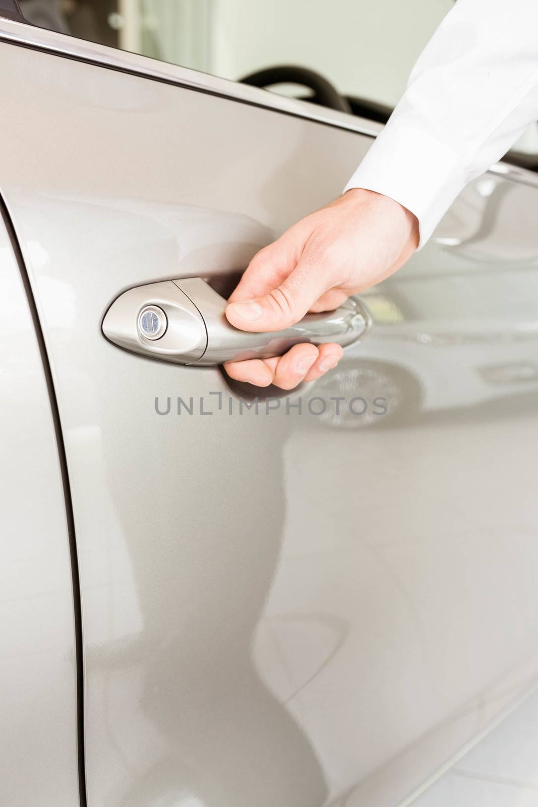  Man holding a car door handles  by Wavebreakmedia
