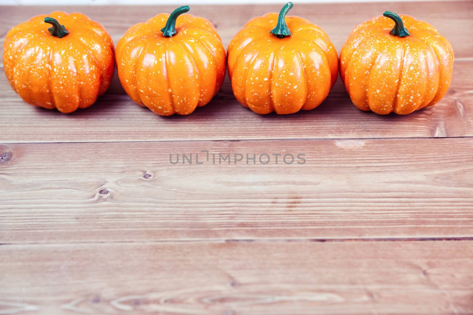 Pumpkin ornaments on desk by Wavebreakmedia