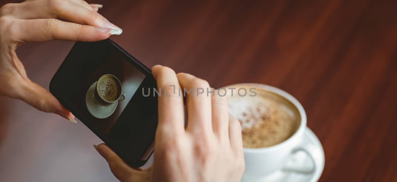 Woman taking a photo of her coffee at the university
