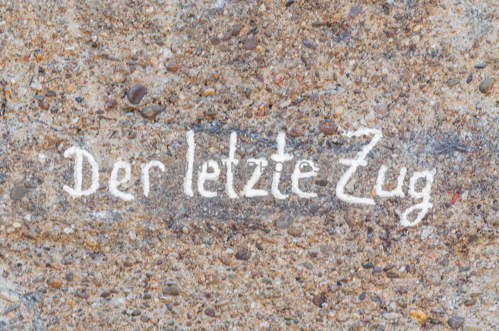 Old concrete wall with inscription in white color, the last train.