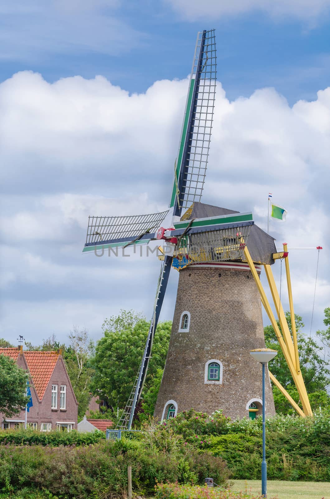 Historic old windmill in the province of Zeeland, Netherlands against blue sky.