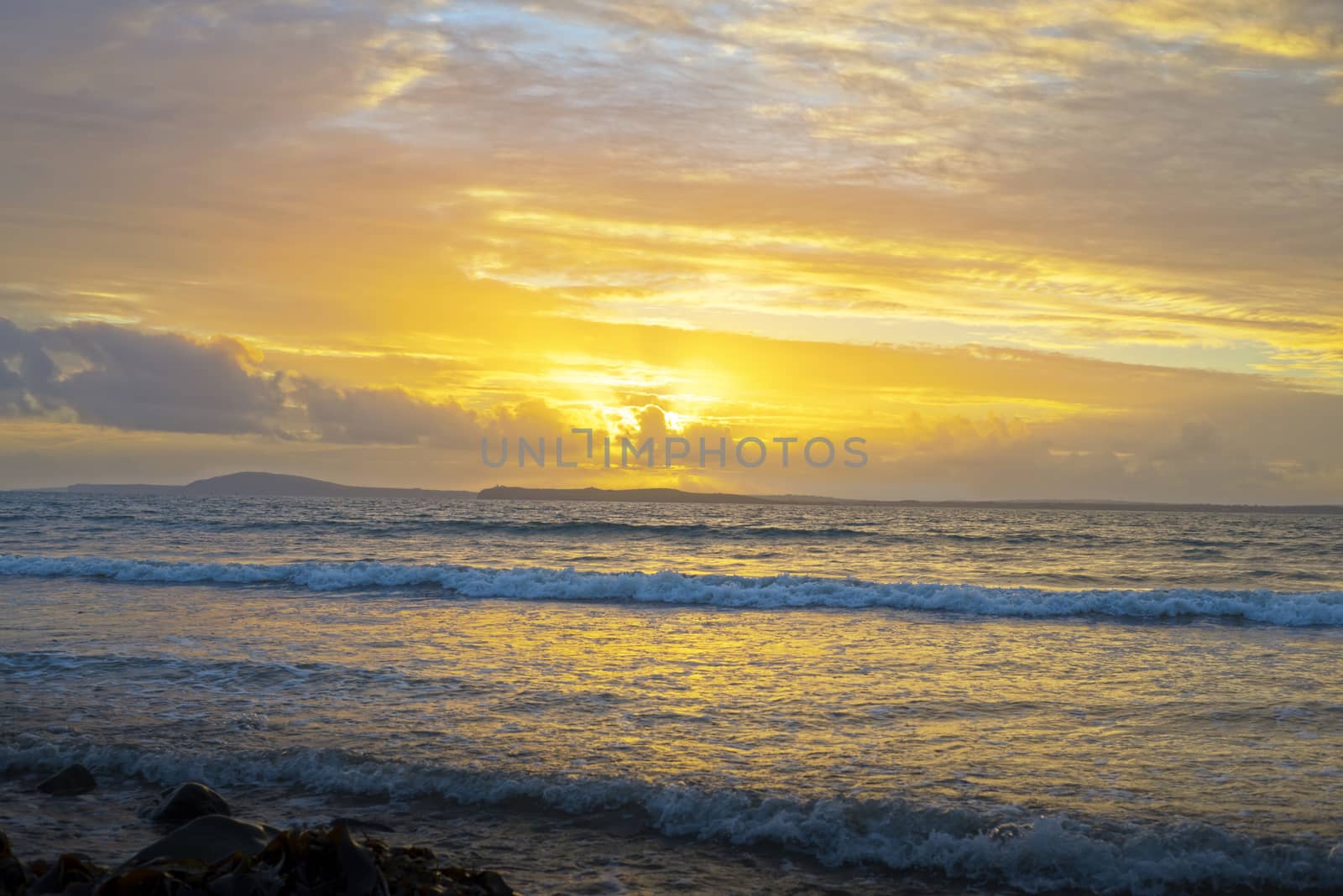 yellow sunset and soft waves at beal beach by morrbyte