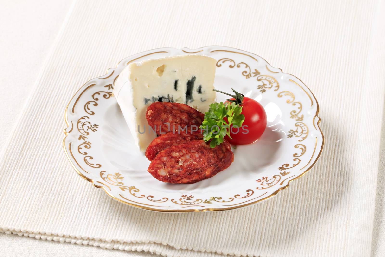 Blue cheese and slices of spicy sausage
