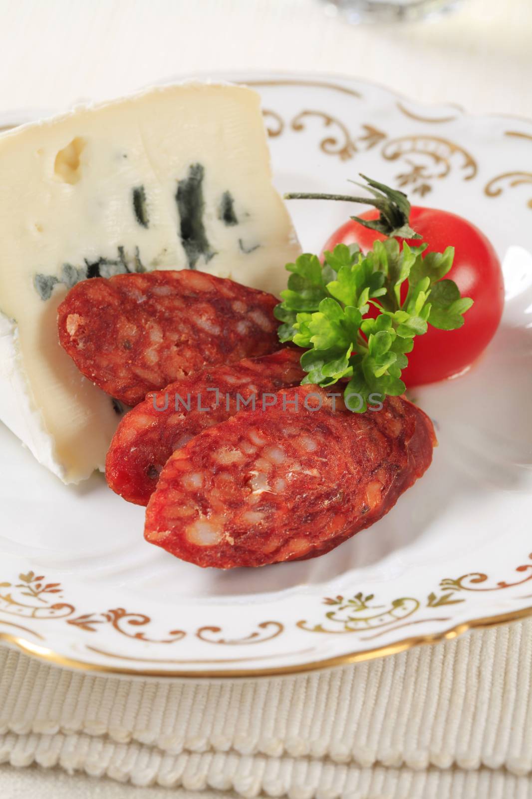 Blue cheese and slices of spicy sausage