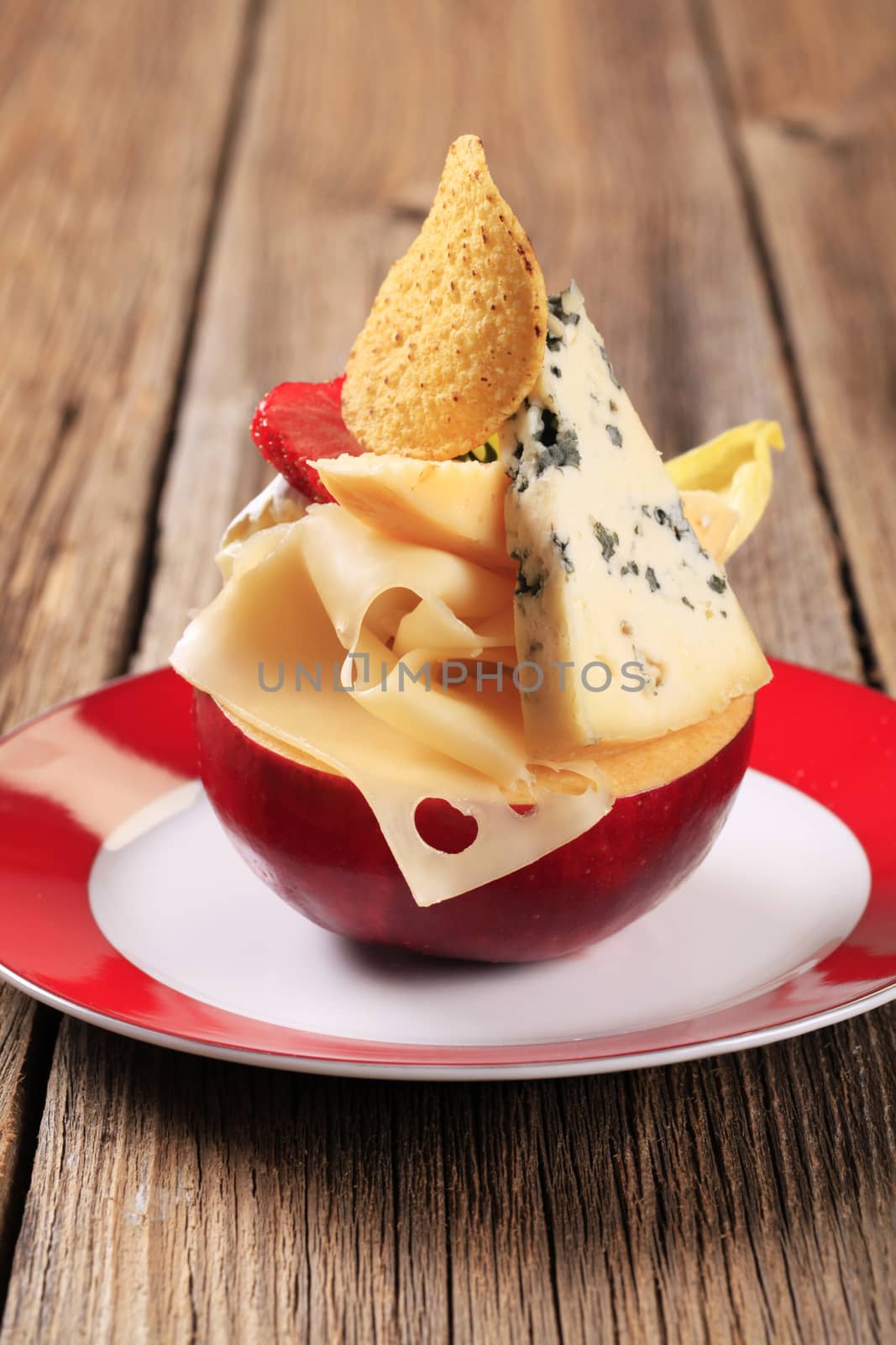 Various types of cheese on an apple