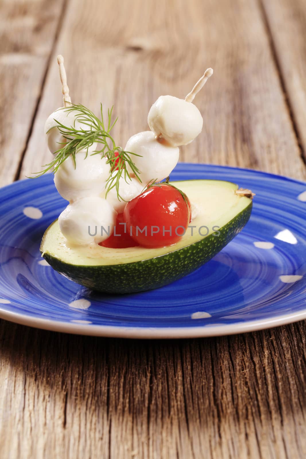 Vegetarian appetizer - Avocado, cherry tomatoes and mozzarella 