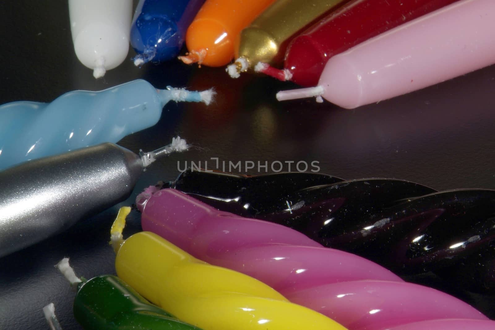 Group of colorful candles on a black background