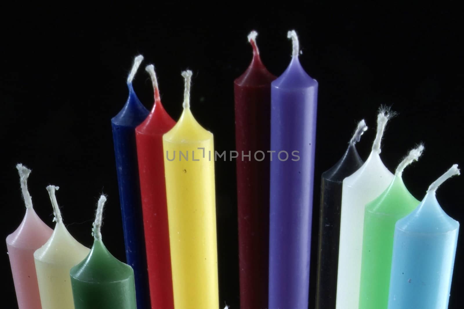 group of colorful cylindrical candles a by diecidodici