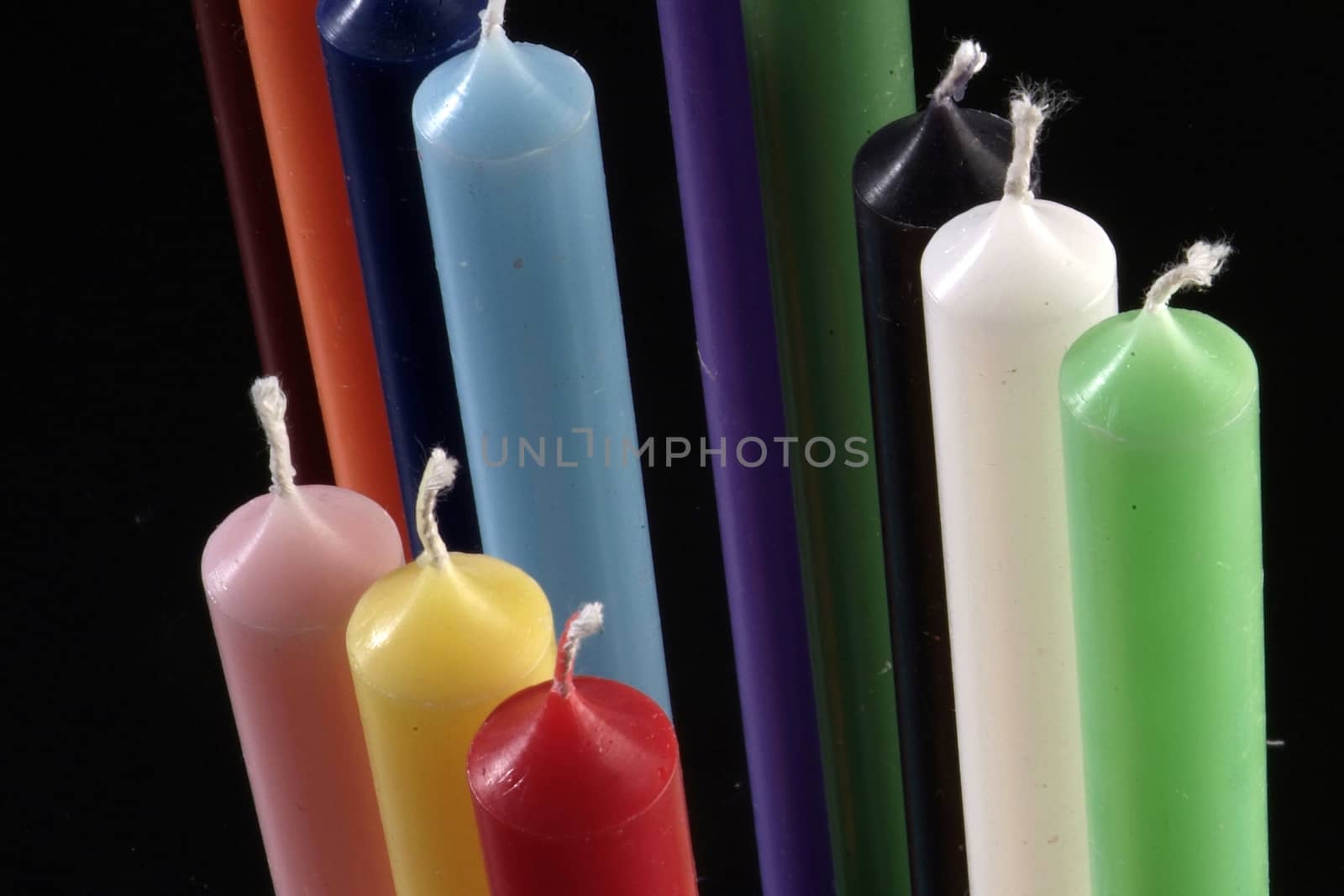 group of colorful cylindrical candles c by diecidodici