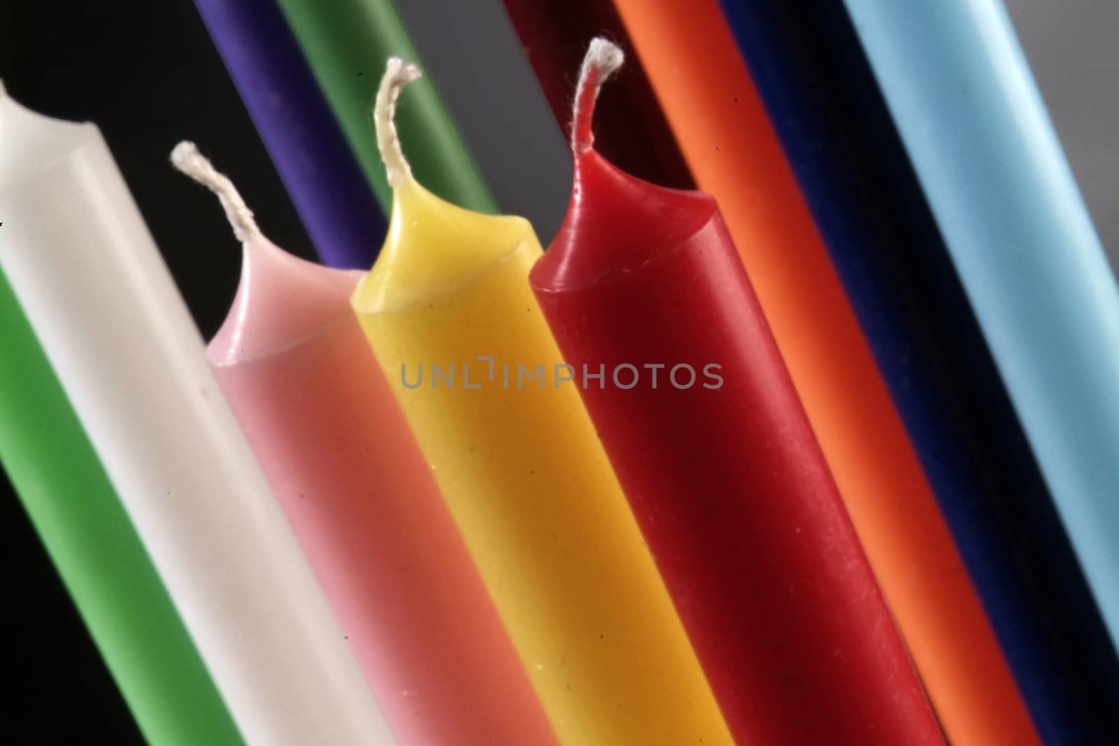 group of colorful cylindrical candles e by diecidodici