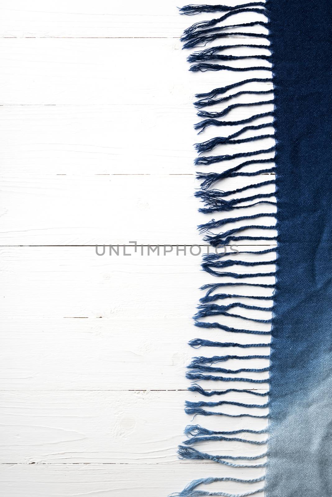 blue scarf over white wood table background