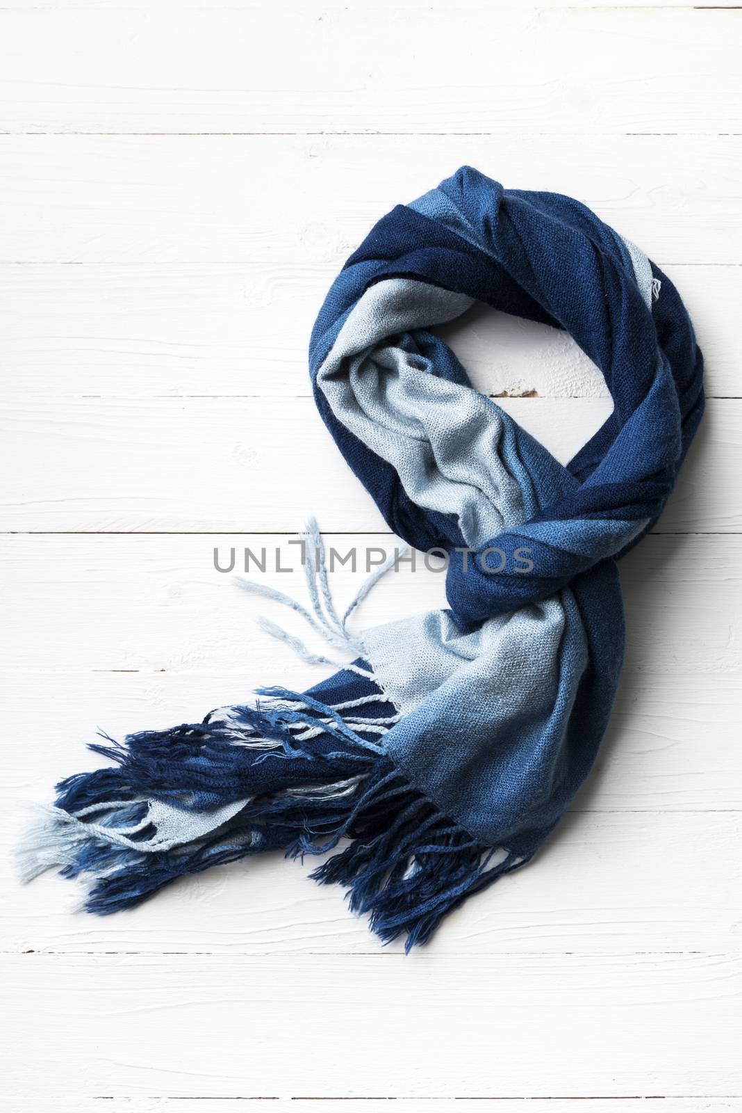 blue scarf over white wood table background