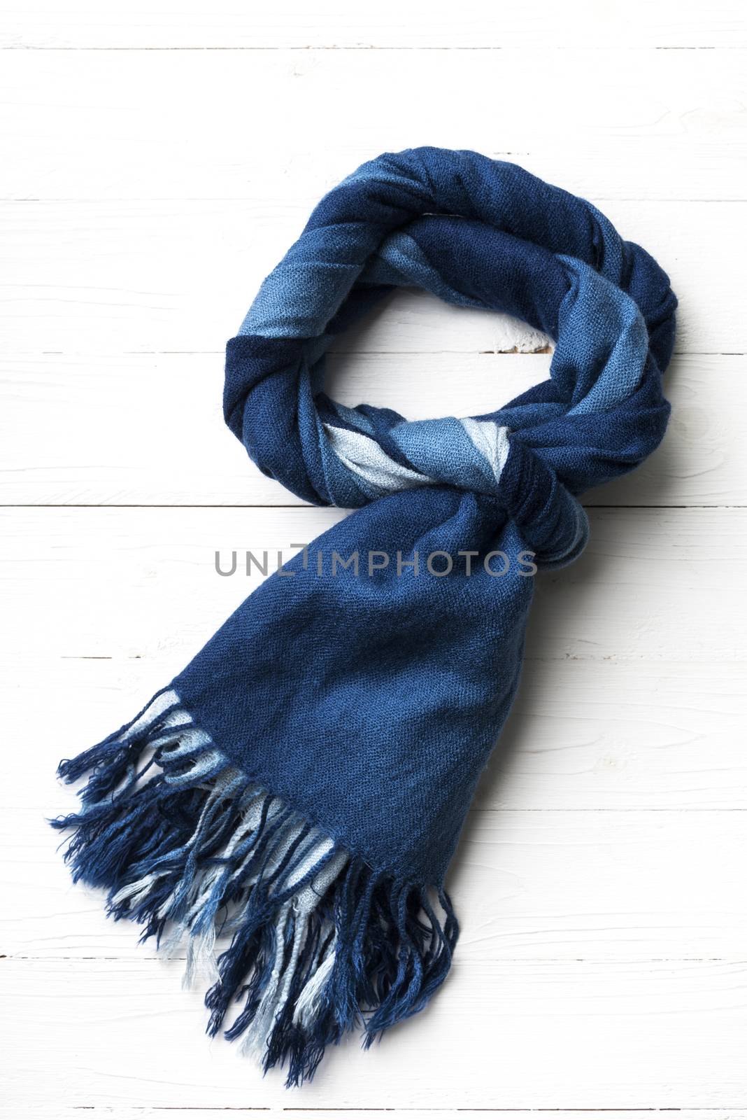 blue scarf over white wood table background