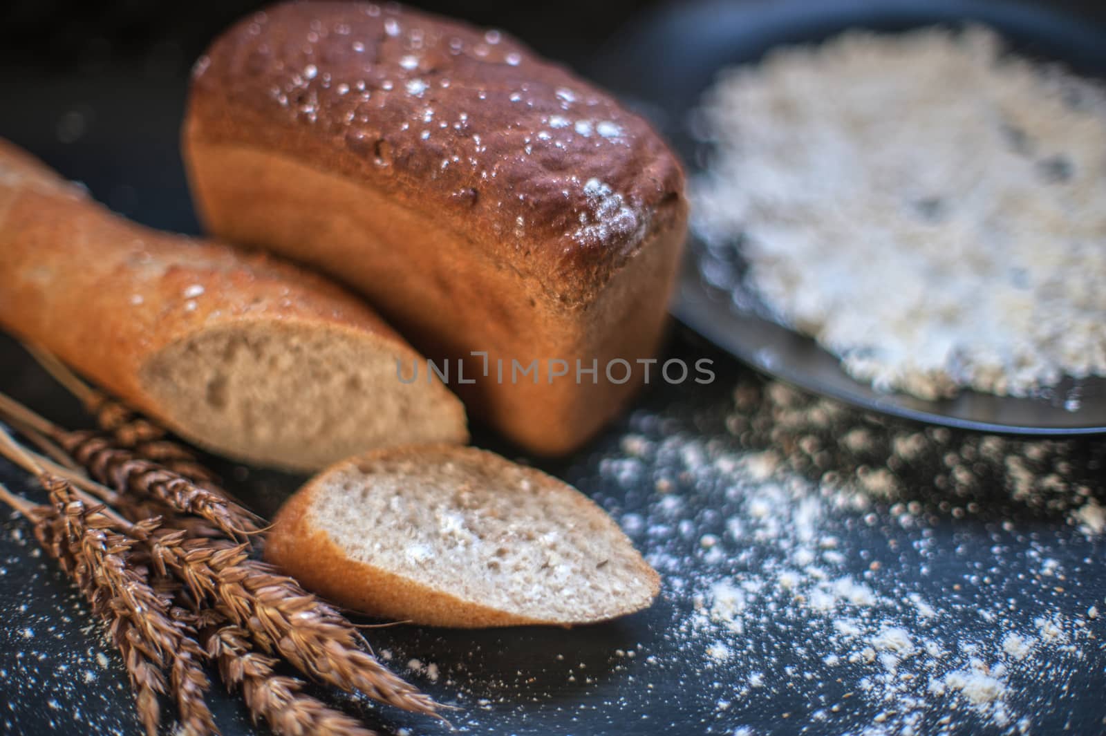 Bread composition with wheats. Very shallow DOF photo and specific art curly bokeh for extra volume.
