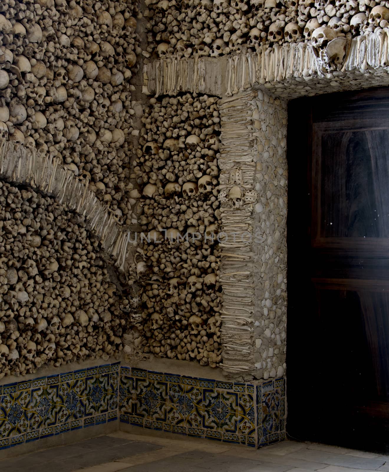 the  Capela dos Ossos  is one of the best known monuments in Évora, Portugal. It is a small interior chapel located next to the entrance of the Church of St. Francis