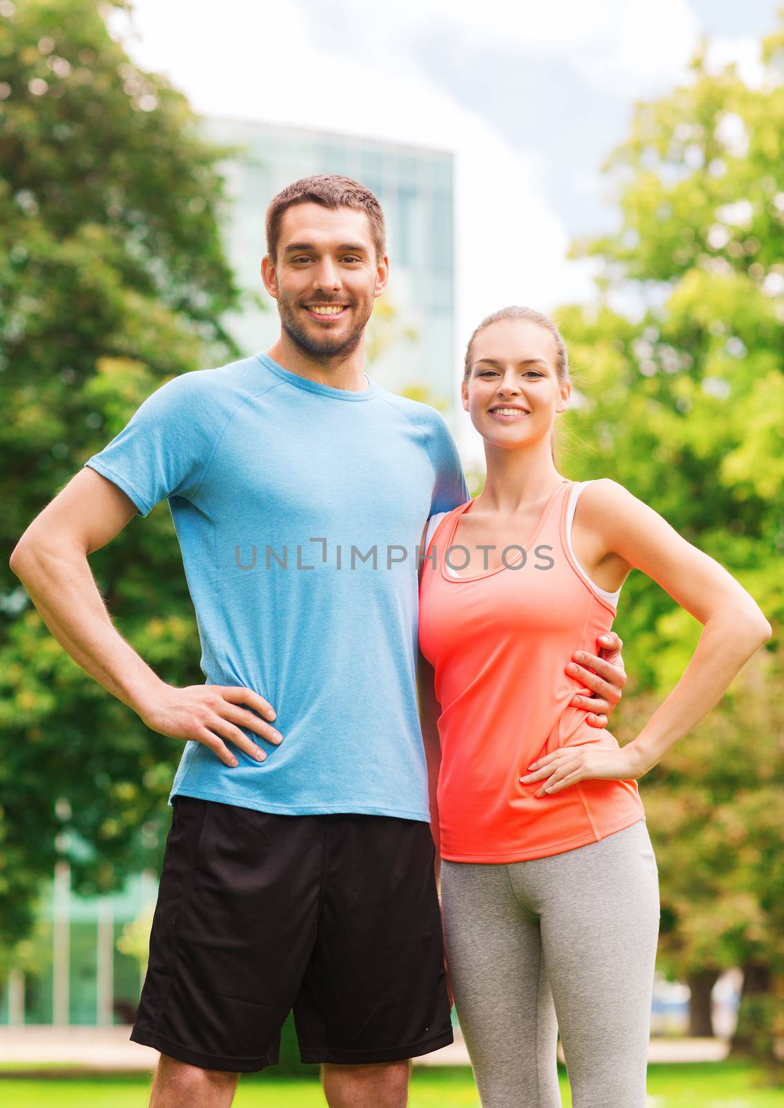 fitness, sport, friendship and lifestyle concept - smiling couple outdoors