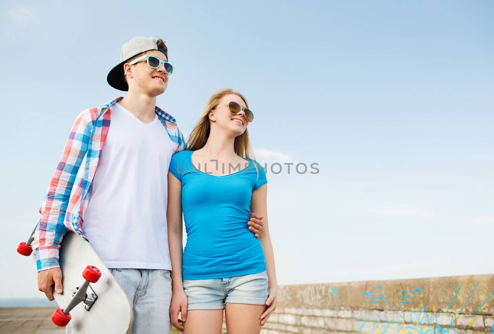 holidays, vacation, love and friendship concept - smiling couple having fun outdoors