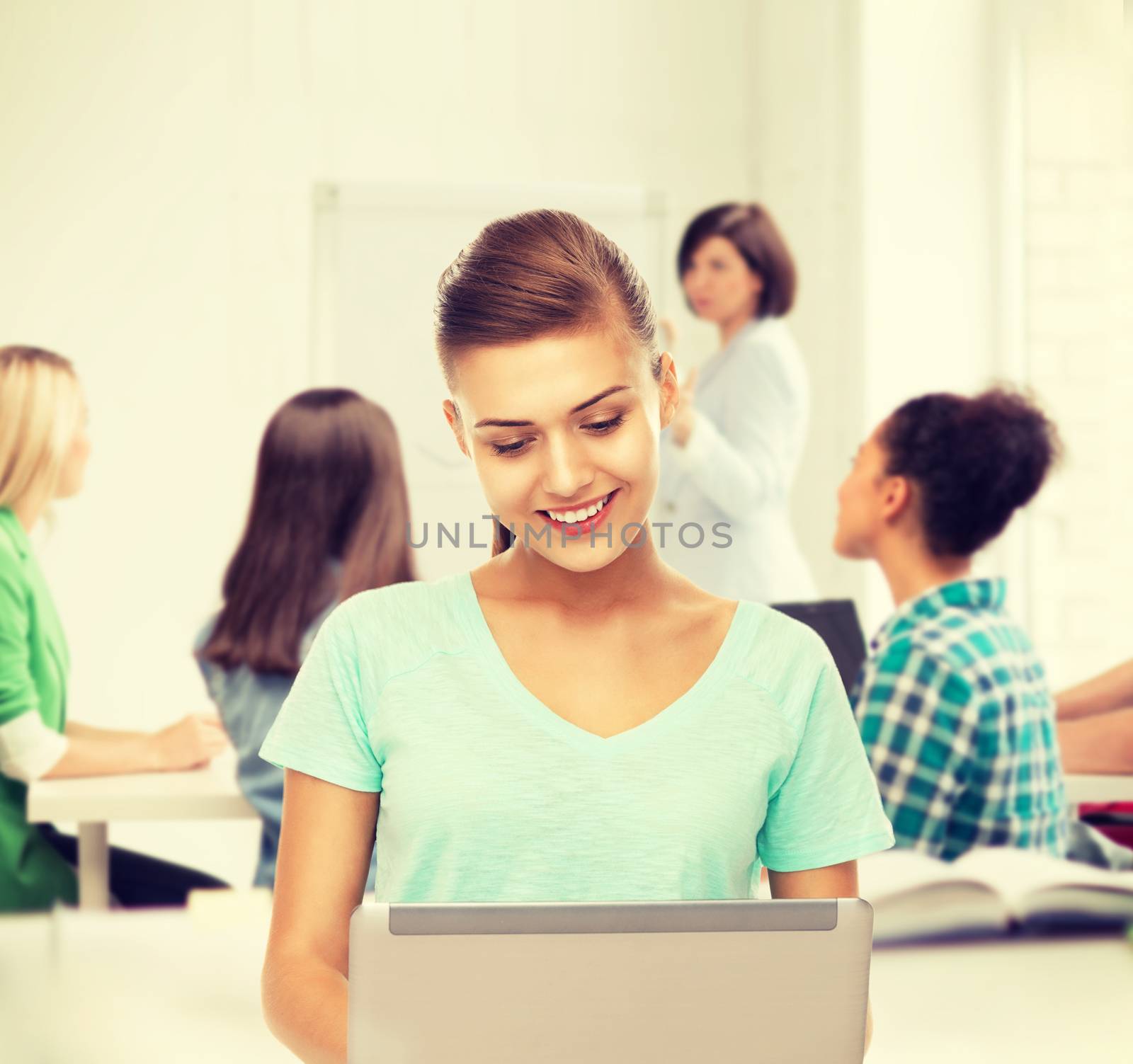 student with laptop at school by dolgachov