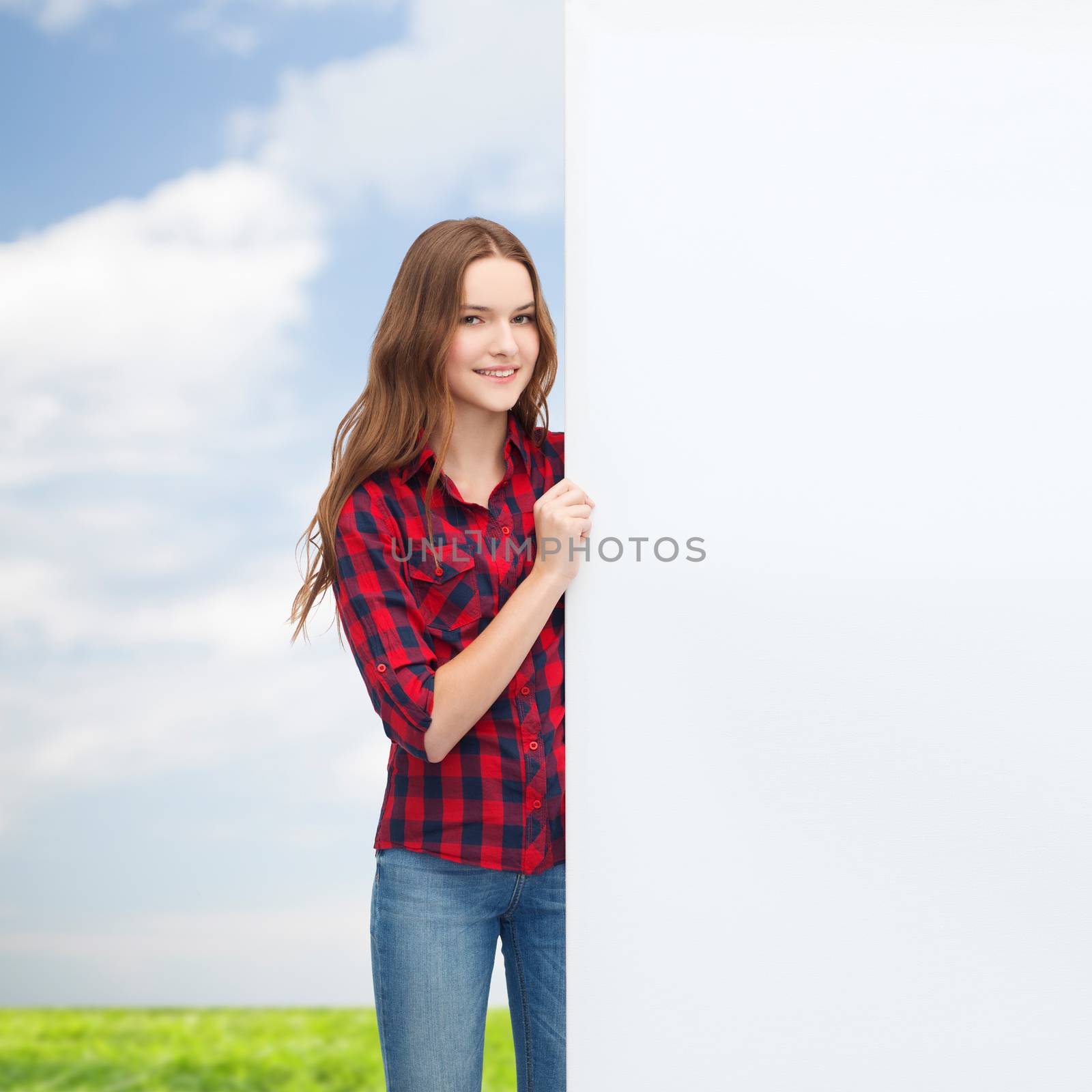 smiling young teenage girl with white blank board by dolgachov