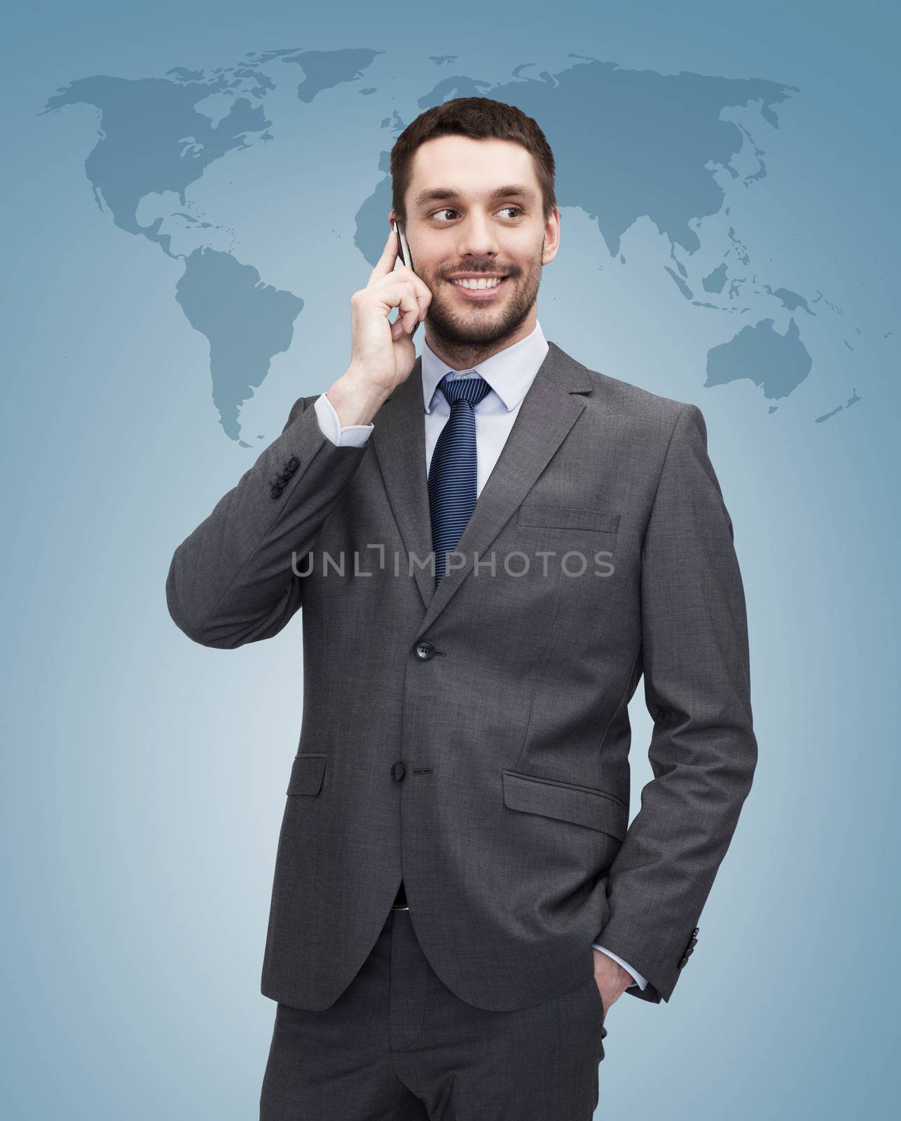young smiling businessman with smartphone by dolgachov