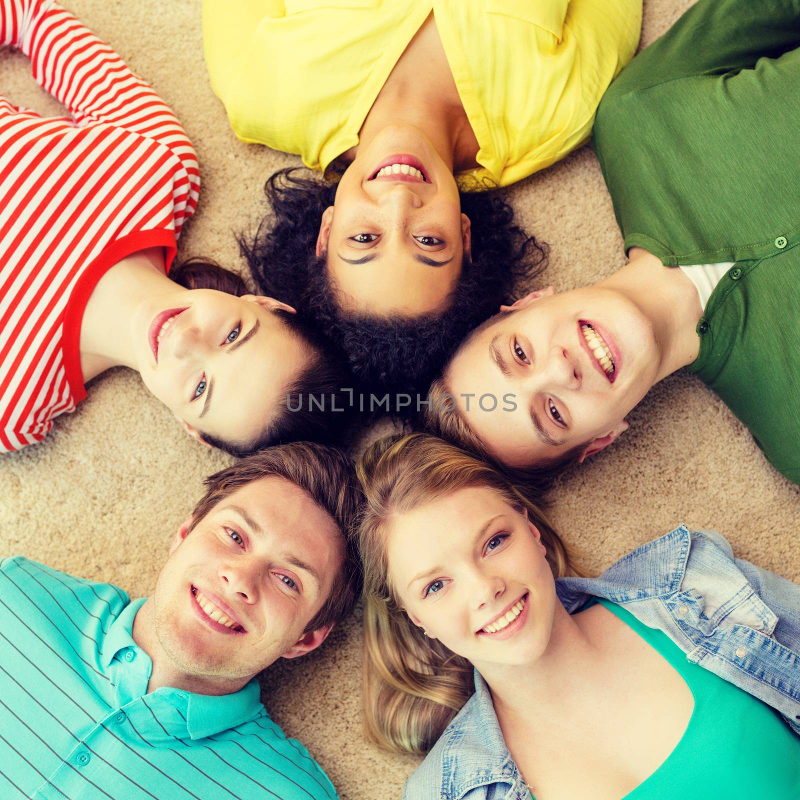 group of smiling people lying down on floor by dolgachov