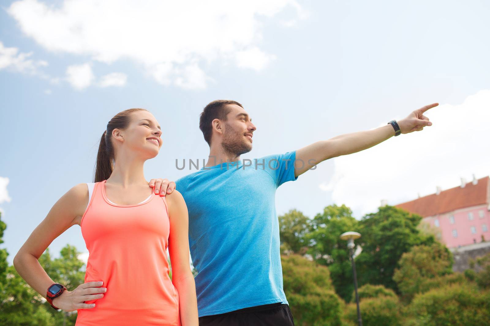 two smiling people outdoors by dolgachov