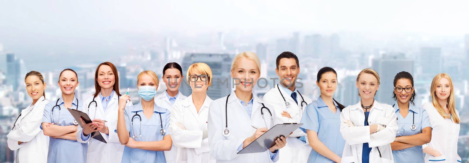 smiling female doctors and nurses with stethoscope by dolgachov