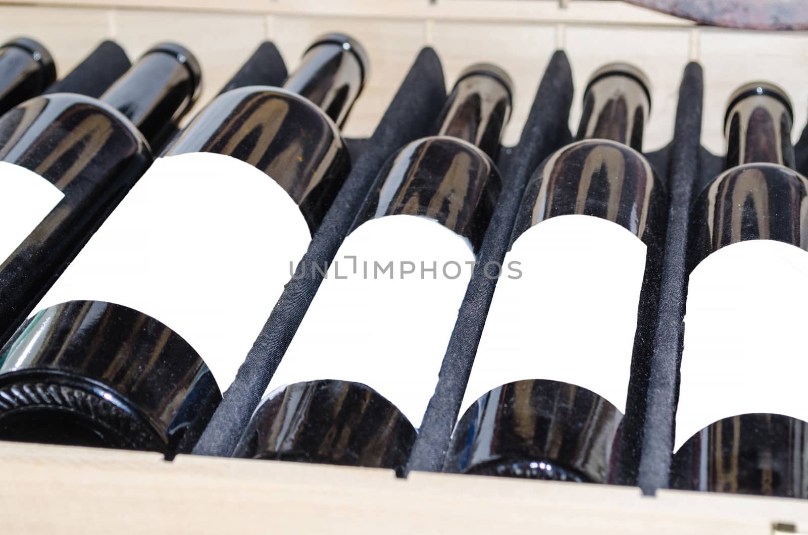 Red and white wine in bottles with white label in a wooden box. 