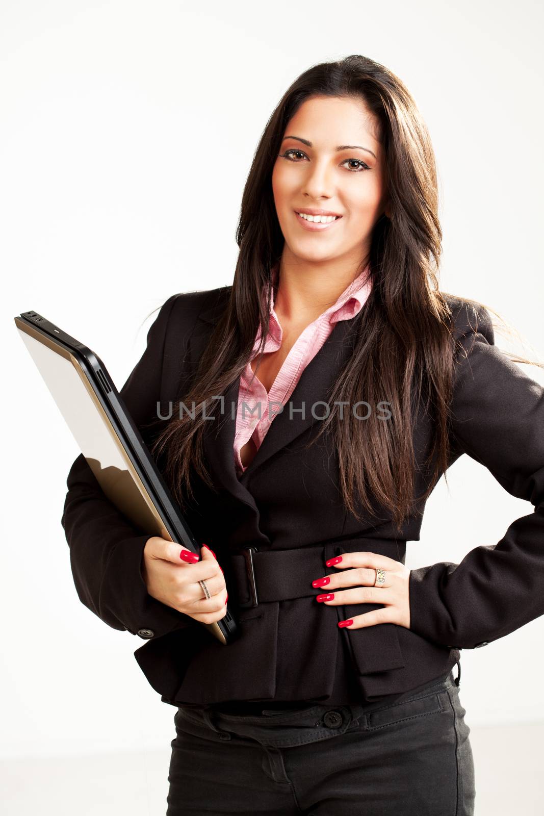 Happy Businesswoman standing and holding laptop. Looking at camera.
