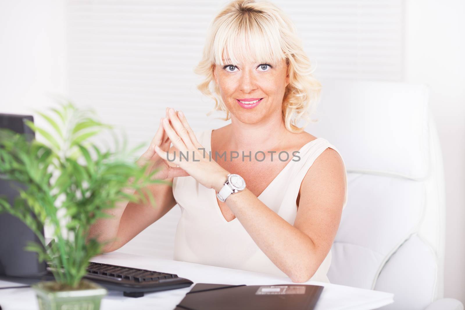 Beautiful mature Business woman sitting in the office