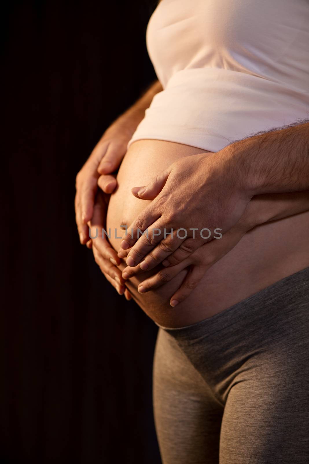 Male And Female Hands On A Pregnant Belly by MilanMarkovic78