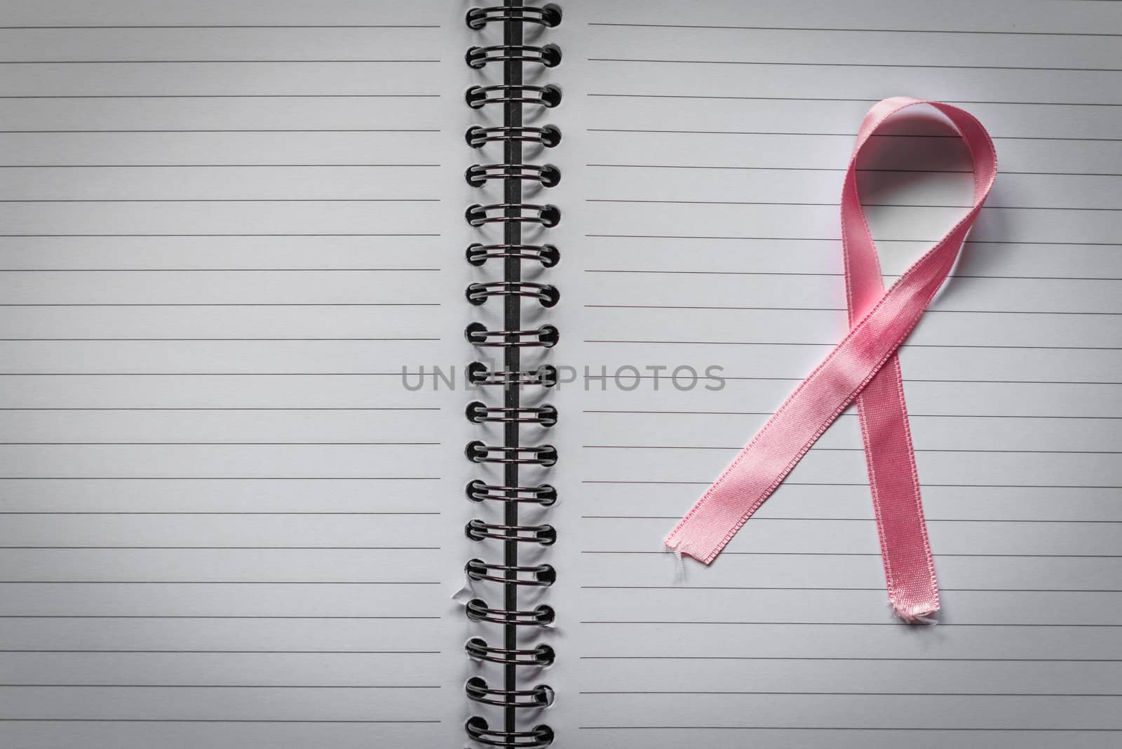 Breast cancer symbol in pink on a noteblok