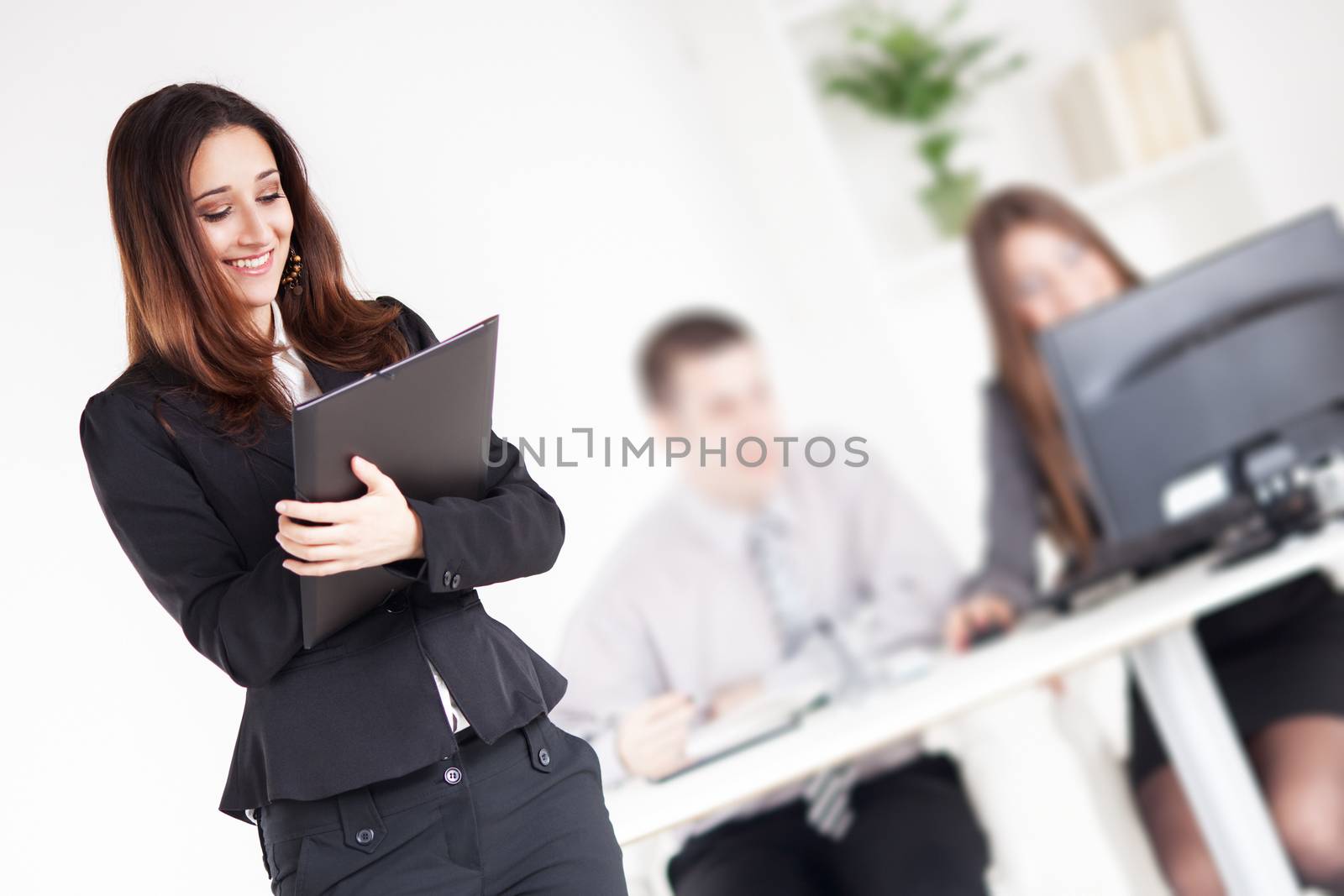 Happy Businesswoman with documents in the office. Selective Focus.